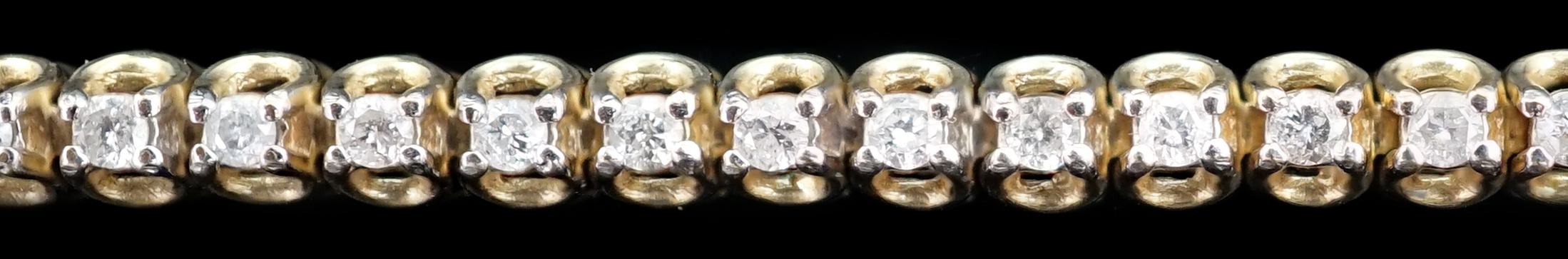 A modern 9ct gold and diamond chip set line bracelet